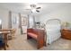 Bedroom with a metal frame bed, desk, and bench under a ceiling fan at 12101 Ranburne Rd, Mint Hill, NC 28227