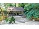 Outdoor gazebo with wood floors, porch swing and draped privacy curtains at 12101 Ranburne Rd, Mint Hill, NC 28227