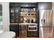 Butler's pantry with wine fridge, storage, stainless appliances and breakfast area at 12101 Ranburne Rd, Mint Hill, NC 28227