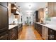Contemporary kitchen with custom cabinets, granite countertops, and hardwood floors at 12101 Ranburne Rd, Mint Hill, NC 28227