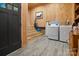 Basement laundry area with washer, dryer, storage cabinets and access to the backyard at 12101 Ranburne Rd, Mint Hill, NC 28227