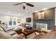 Spacious living room with a fireplace, french doors, and a comfortable leather sofa at 12101 Ranburne Rd, Mint Hill, NC 28227