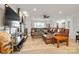 Bright and airy living room features a fireplace, television, and leather sofa at 12101 Ranburne Rd, Mint Hill, NC 28227
