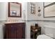 Charming powder room features vanity with marble top and decorative mirror at 12101 Ranburne Rd, Mint Hill, NC 28227