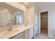 Bright bathroom featuring double sinks, white countertops, and a glass-enclosed shower, beautifully designed at 143 Astor St, Troutman, NC 28166