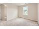 Cozy bedroom with plush carpet, natural light, and a serene atmosphere, ideal for relaxation at 143 Astor St, Troutman, NC 28166
