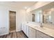 Bathroom featuring dual sinks, a large mirror, and a shower with glass door at 149 Astor St, Troutman, NC 28166