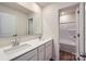 Bathroom featuring double sinks, a large mirror, white cabinetry, and a shower-tub combo at 149 Astor St, Troutman, NC 28166