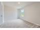Neutral bedroom with carpet flooring, a window, and a closet at 149 Astor St, Troutman, NC 28166