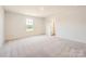 Spacious bedroom featuring plush carpeting, a window, and an ensuite bathroom at 149 Astor St, Troutman, NC 28166