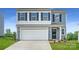 Charming two-story home with a two-car garage, blue accents, and well-manicured lawn at 149 Astor St, Troutman, NC 28166