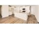 Modern kitchen with white cabinets, stainless steel appliances, and a center island at 149 Astor St, Troutman, NC 28166