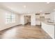 Open-concept living area with hardwood floors, white walls and abundant natural light at 149 Astor St, Troutman, NC 28166