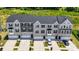 Aerial view of newly constructed townhomes with well-maintained landscaping and private driveways at 2040 Dornoch Rd, Tega Cay, SC 29708