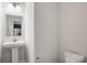 Modern half bath with pedestal sink, neutral walls, and convenient powder room at 2040 Dornoch Rd, Tega Cay, SC 29708
