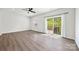 Bright bedroom boasts a ceiling fan, sliding glass doors to balcony, and wood-look flooring at 2040 Dornoch Rd, Tega Cay, SC 29708