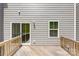Back deck showing wood railings, siding, a door and a window at 2040 Dornoch Rd, Tega Cay, SC 29708