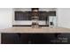 Gourmet kitchen features granite counters, stainless steel appliances, an island with sink, and dark cabinetry at 2040 Dornoch Rd, Tega Cay, SC 29708