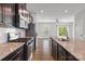 Bright, open kitchen with granite counters, stainless steel appliances, and access to the living area at 2040 Dornoch Rd, Tega Cay, SC 29708