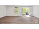 Spacious living room with wood-look flooring, view of backyard, and natural light from windows at 2040 Dornoch Rd, Tega Cay, SC 29708