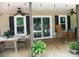 Back porch with plants, tables, seating, ceiling fans, and open view to the outside at 257 Rolling View Dr, New London, NC 28127