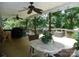Relaxing back porch with wooden floors, ceiling fans, dining table, grill and hanging swing at 257 Rolling View Dr, New London, NC 28127