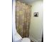 Cozy bathroom features a floral shower curtain and a dachshund soap sign at 257 Rolling View Dr, New London, NC 28127