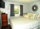 Bedroom featuring a queen-sized bed, hardwood floors, and natural light from the window at 257 Rolling View Dr, New London, NC 28127