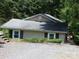 Cozy bungalow home with a gravel driveway and lots of surrounding trees at 257 Rolling View Dr, New London, NC 28127
