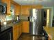 Kitchen featuring stainless steel refrigerator, dark countertops and wood cabinets at 257 Rolling View Dr, New London, NC 28127