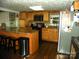 Well-lit kitchen featuring wood cabinets, stainless steel appliances, and a breakfast bar at 257 Rolling View Dr, New London, NC 28127