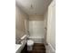 Bright bathroom featuring a tiled shower and bathtub combo, white tile walls and granite vanity at 268 Hatley Ne Cir, Concord, NC 28025