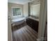 Beautiful bathroom with a soaking tub, dual sink vanity, and wood flooring at 268 Hatley Ne Cir, Concord, NC 28025