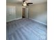 Bedroom features gray carpeting, a ceiling fan and closet with double doors at 268 Hatley Ne Cir, Concord, NC 28025