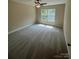 Bedroom with large window and neutral carpeting and paint at 268 Hatley Ne Cir, Concord, NC 28025