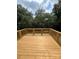 Newly constructed deck with wood planks and rails overlooking mature trees at 268 Hatley Ne Cir, Concord, NC 28025