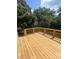 New wood deck featuring wood railing, overlooks mature trees in the yard at 268 Hatley Ne Cir, Concord, NC 28025