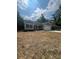 Charming one-story home featuring gray siding, black shutters, and an attached garage, surrounded by a partially unkempt yard at 268 Hatley Ne Cir, Concord, NC 28025