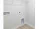 This small laundry room has a wire rack for storage, utility hookups, and vinyl wood-look flooring at 3029 Ora Smith Rd, Lincolnton, NC 28092