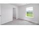 Bright bedroom featuring a window with a green view and doorway to a closet at 3037 Ora Smith Rd, Lincolnton, NC 28092