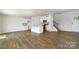 Open living space featuring hardwood floors, a kitchen island, white cabinets, and modern finishes at 3037 Ora Smith Rd, Lincolnton, NC 28092