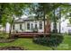 Spacious backyard with a wooden deck, lush greenery, and mature trees at 3422 Balsam Tree Dr, Charlotte, NC 28269