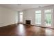Spacious living room featuring a fireplace, hardwood floors, and large windows for ample natural light at 3422 Balsam Tree Dr, Charlotte, NC 28269