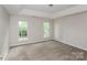 Serene main bedroom with tray ceiling, plush carpet, and large windows with natural light at 3422 Balsam Tree Dr, Charlotte, NC 28269