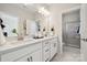 Modern bathroom featuring a double vanity with white countertops, sleek fixtures, and a separate shower at 4010 Caymen Bay Ct, Tega Cay, SC 29708