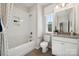 Well-lit bathroom with a bathtub, tiled shower, and granite vanity, providing a functional space at 4010 Caymen Bay Ct, Tega Cay, SC 29708
