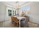 Bright dining room with large windows, a modern chandelier, and stylish furniture and decor at 4010 Caymen Bay Ct, Tega Cay, SC 29708