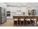 Bright kitchen showcasing white cabinets, a center island with seating, and stainless-steel appliances at 4010 Caymen Bay Ct, Tega Cay, SC 29708