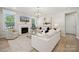 Bright living room featuring plush white couches, fireplace, decorative lighting, and neutral tones at 4010 Caymen Bay Ct, Tega Cay, SC 29708