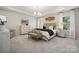 Spacious primary bedroom with tray ceiling, a luxurious bed, and ample natural light at 4010 Caymen Bay Ct, Tega Cay, SC 29708